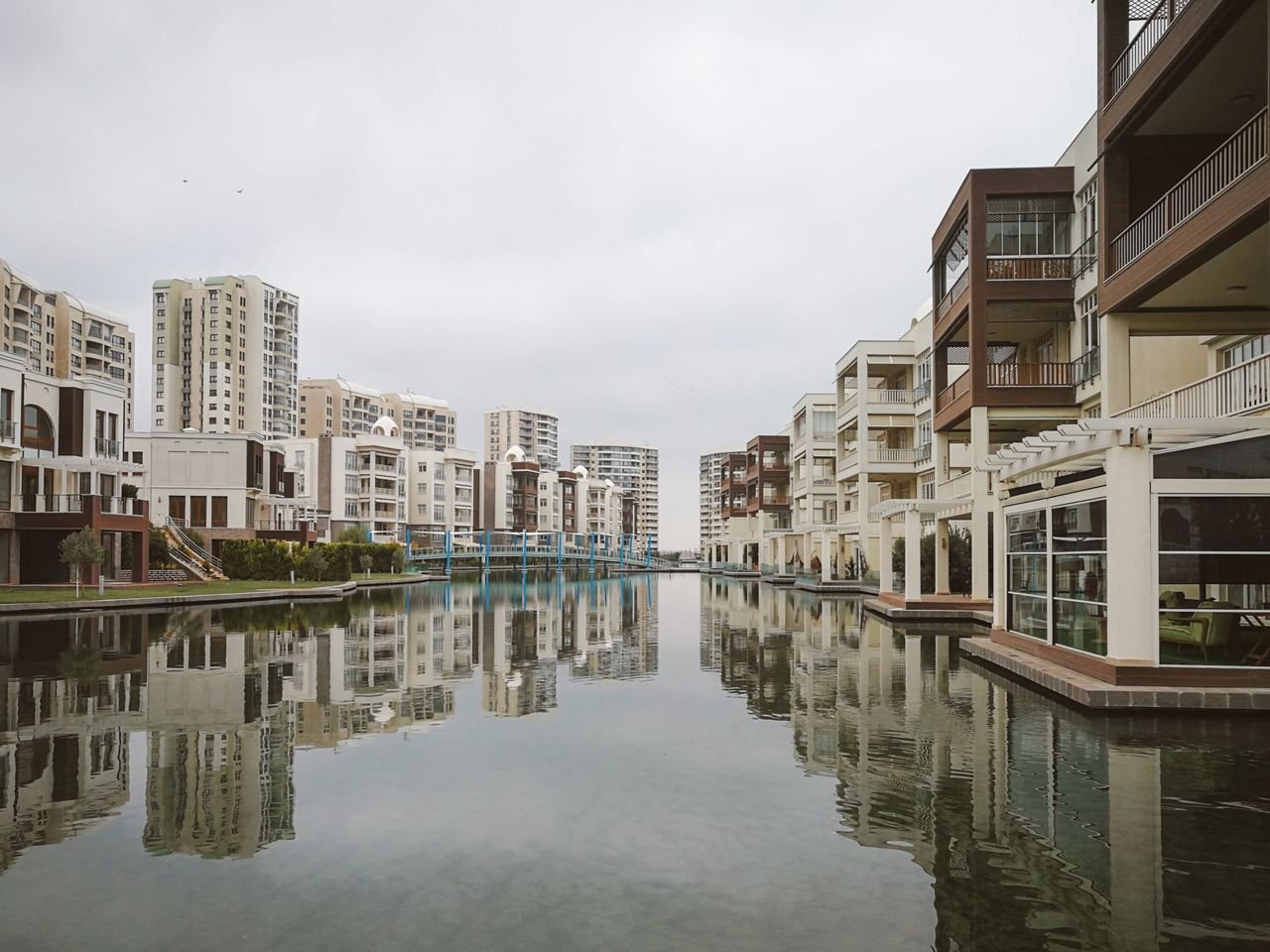 Crafting Captivating Headlines: Your awesome post title goes here Modern residential buildings reflecting in a tranquil urban canal.