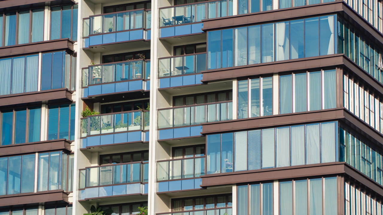 The Art of Drawing Readers In: Your attractive post title goes here Close-up view of modern glass apartment facade with balconies and reflections.